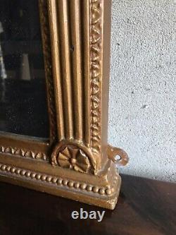 Gilt frame wall hanging mirror flanked each side with small mirrors