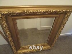 Large ornately framed wall mirror with bevelled glass excellent condition