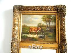 Tall beveled glass wall mirror in gold wood frame cow painting on board