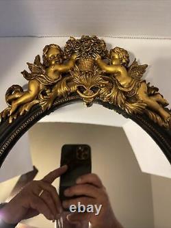 Vintage Mid Century Oval Wall Mirror with Gold Color Ornate Frame. (Trkng ALST)
